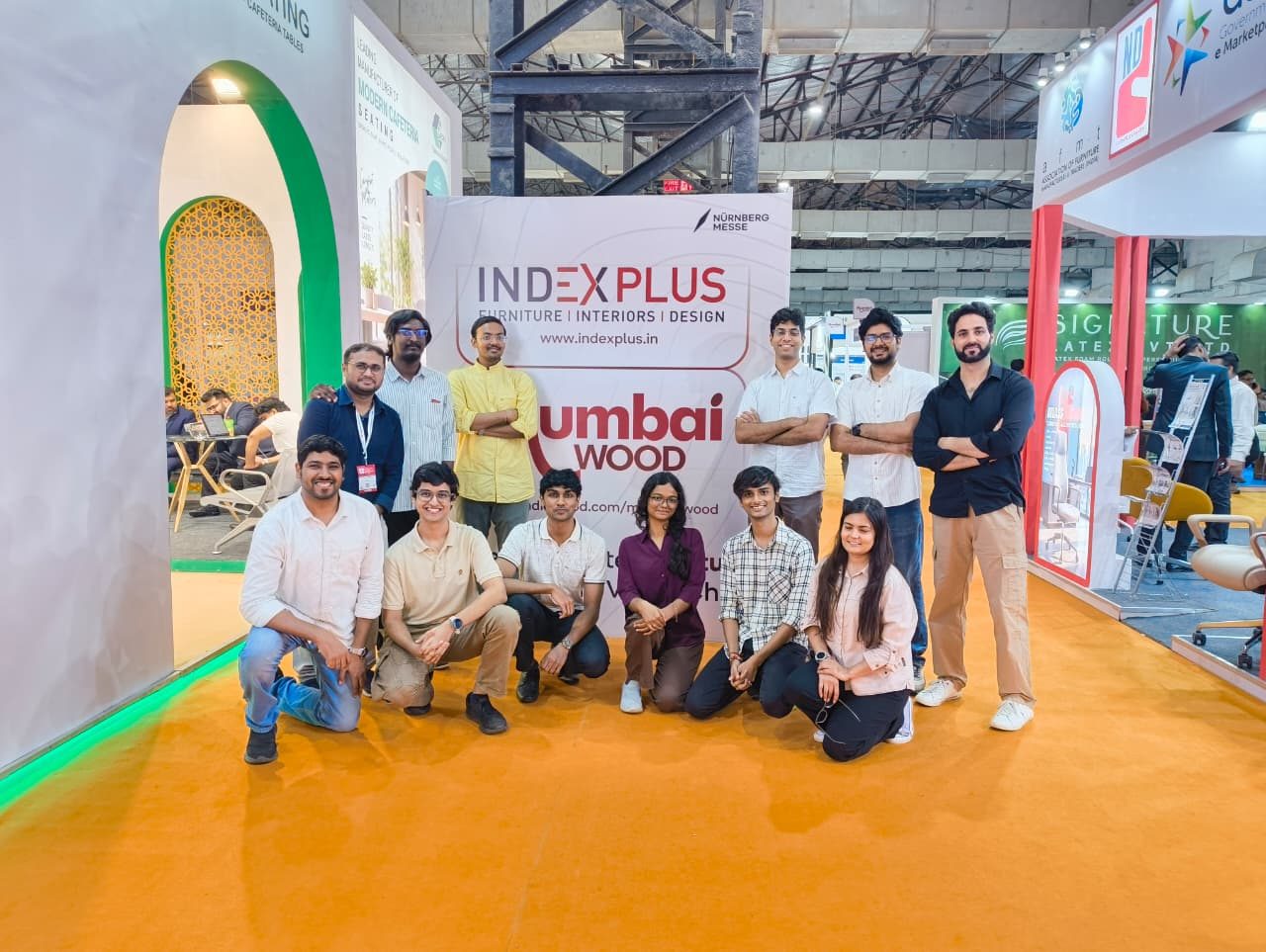 Team D-sign in front of the INDEXPLUS Mumbai 2026 banner